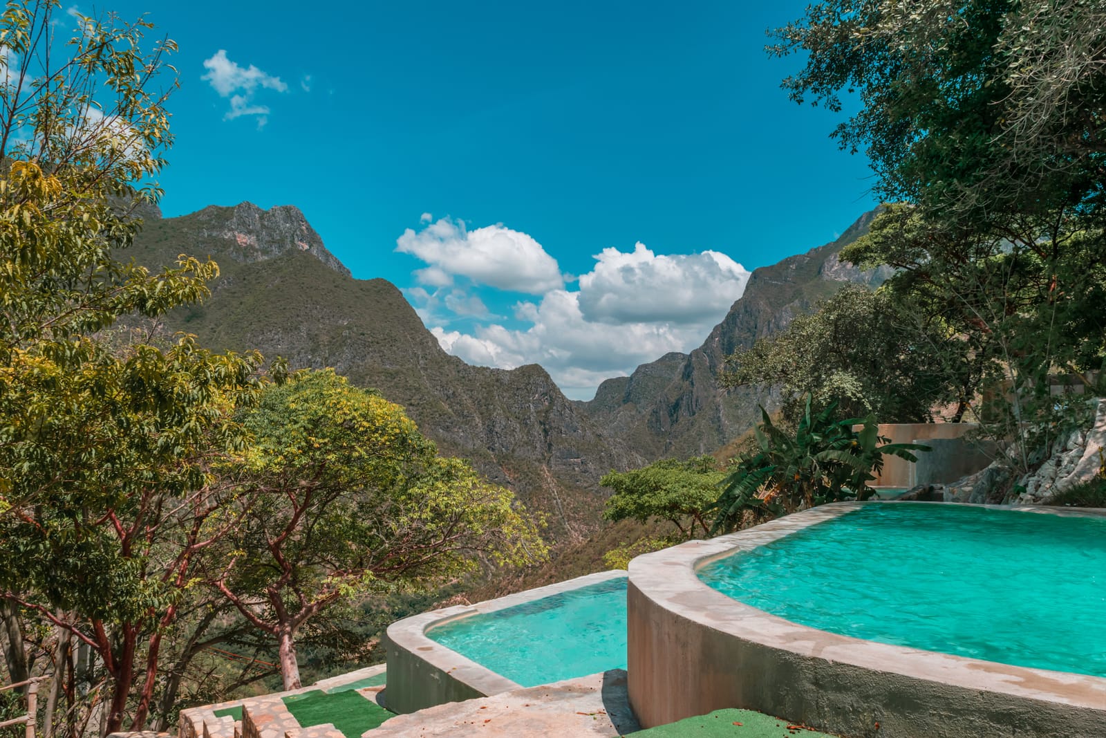 Turquoise thermal pools on the hillside overlooking the canyon