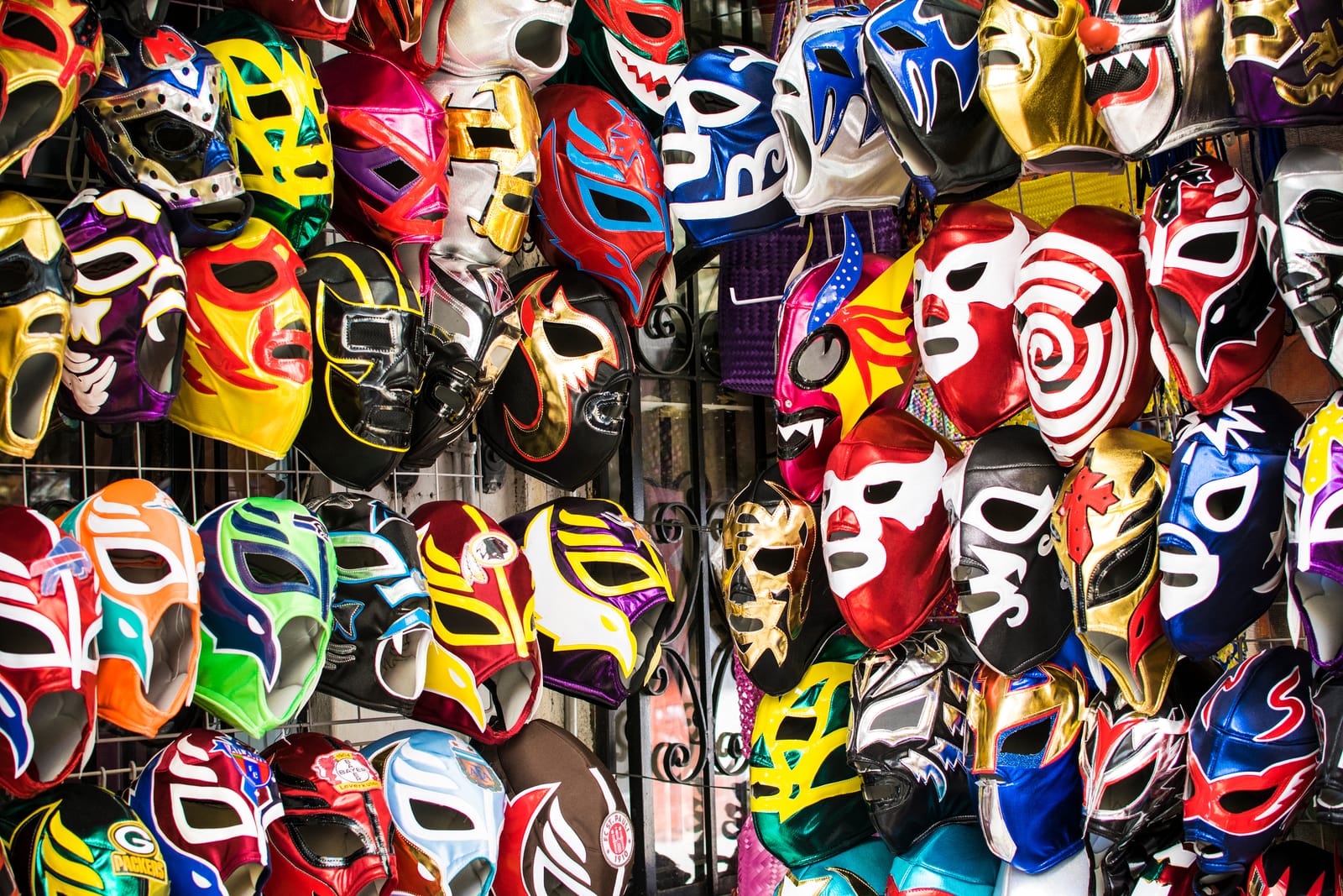 A wall of colorful lucha libre masks